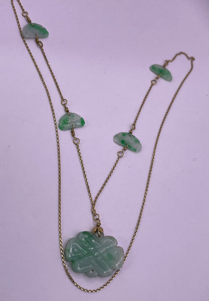 A vintage Art Deco style necklace with an antique apple green jade carved plaque and smaller plaques on 14kt chain
