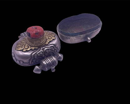 An antique silver and coral ghau amulet