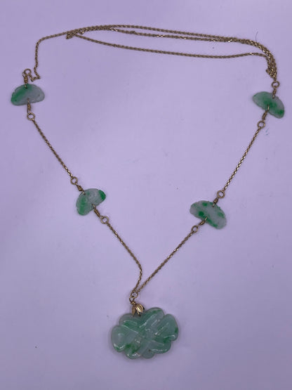 A vintage Art Deco style necklace with an antique apple green jade carved plaque and smaller plaques on 14kt chain