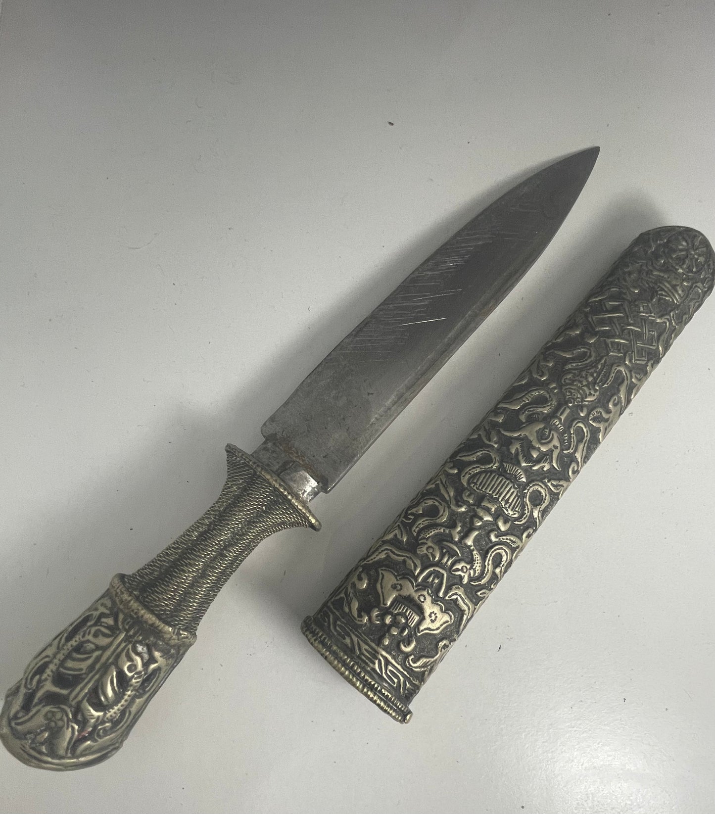 A vintage Tibetan dagger with a carved sheath