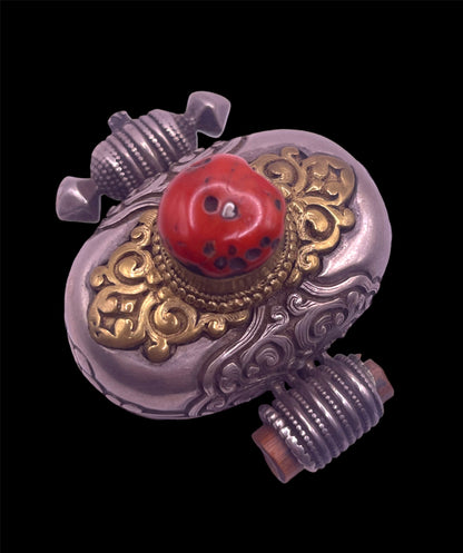 An antique silver and coral ghau amulet