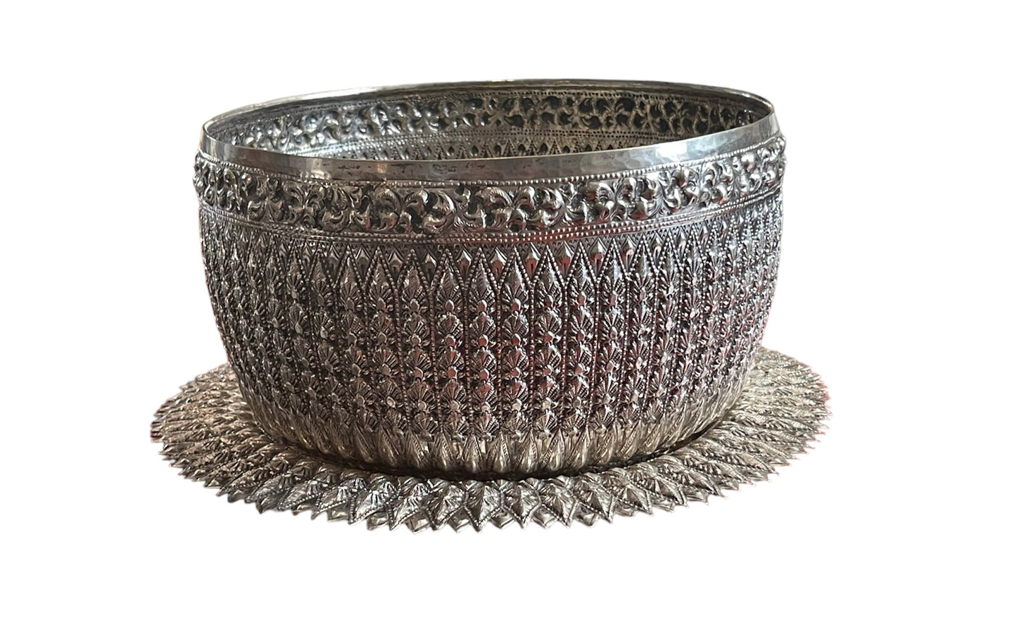 An antique southeast Asian large carved silver bowl and plate