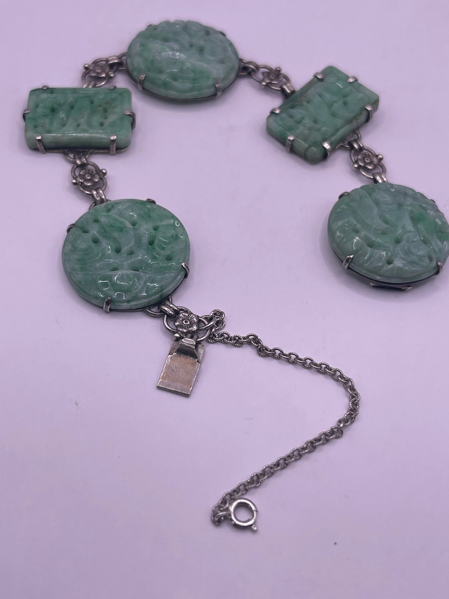 A silver bracelet with jade plaques