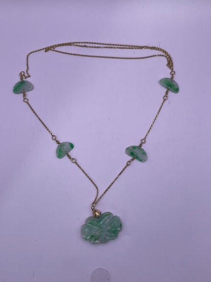 A vintage Art Deco style necklace with an antique apple green jade carved plaque and smaller plaques on 14kt chain