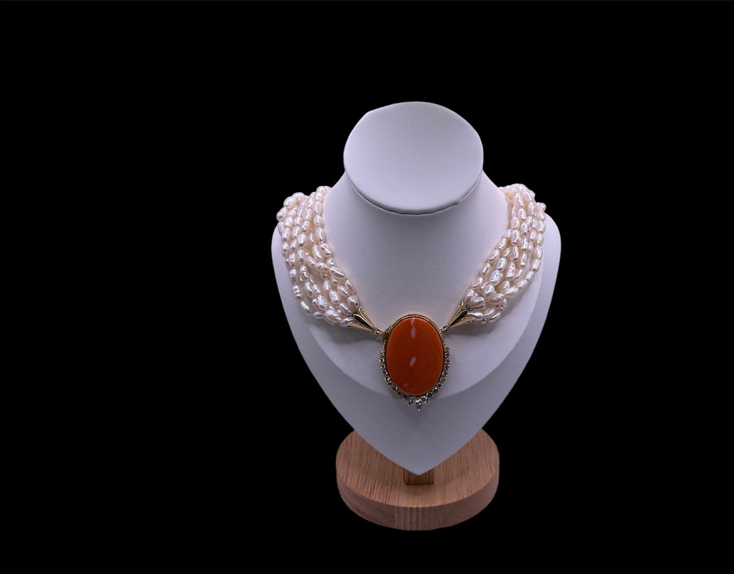 A pearl torsade with coral clasp