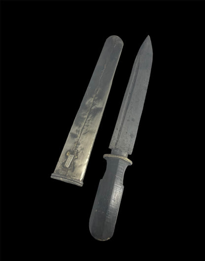 An antique Tibetan dagger with a carved silver sheath