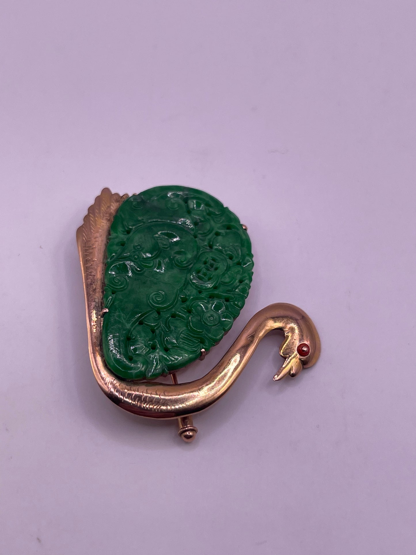 A jade plaque pin in a gold setting