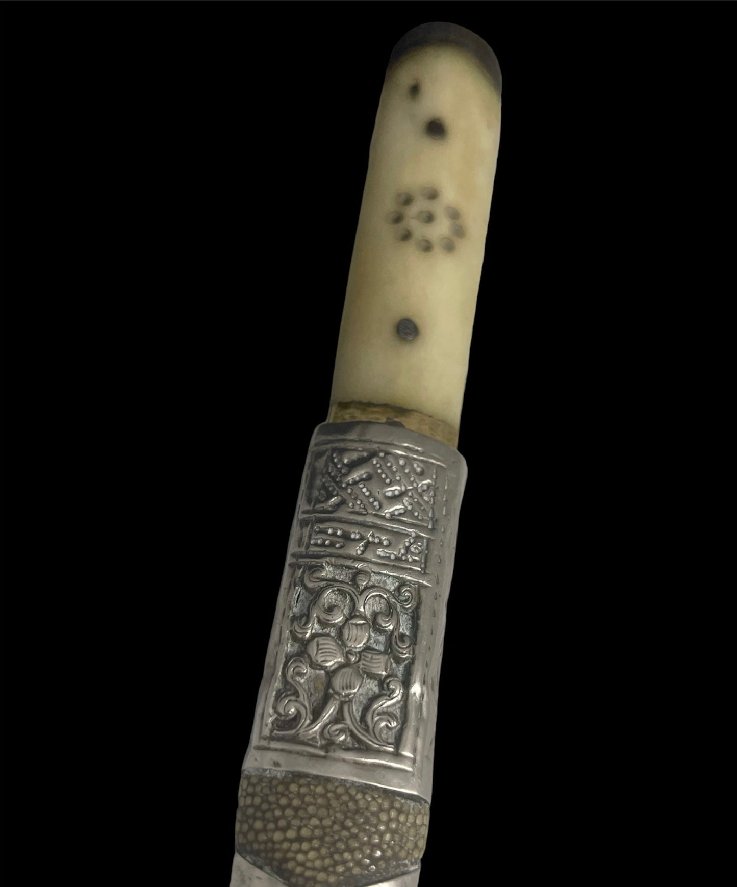 An antique Tibetan dagger with a carved silver sheath