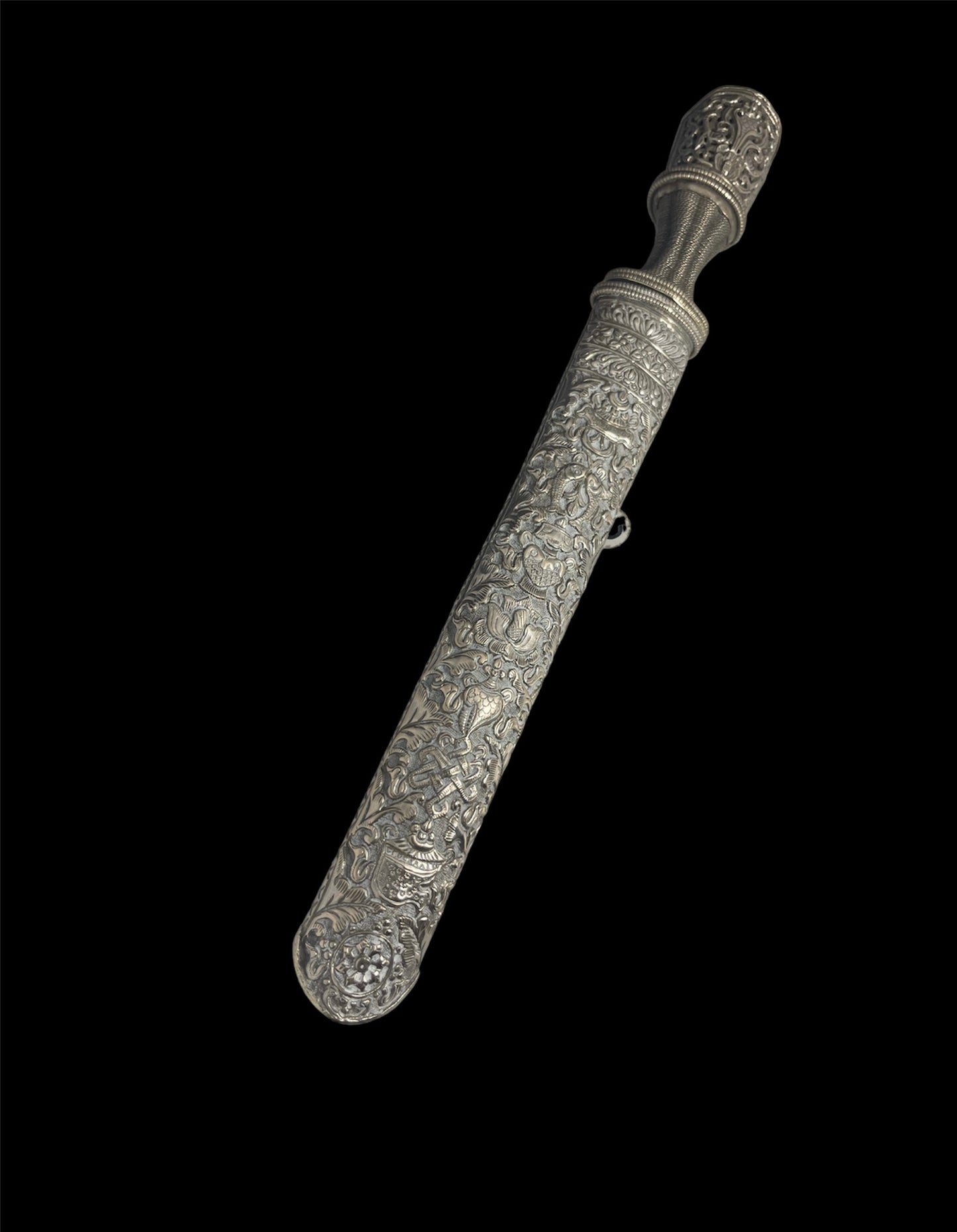 An antique Tibetan dagger with a carved silver sheath