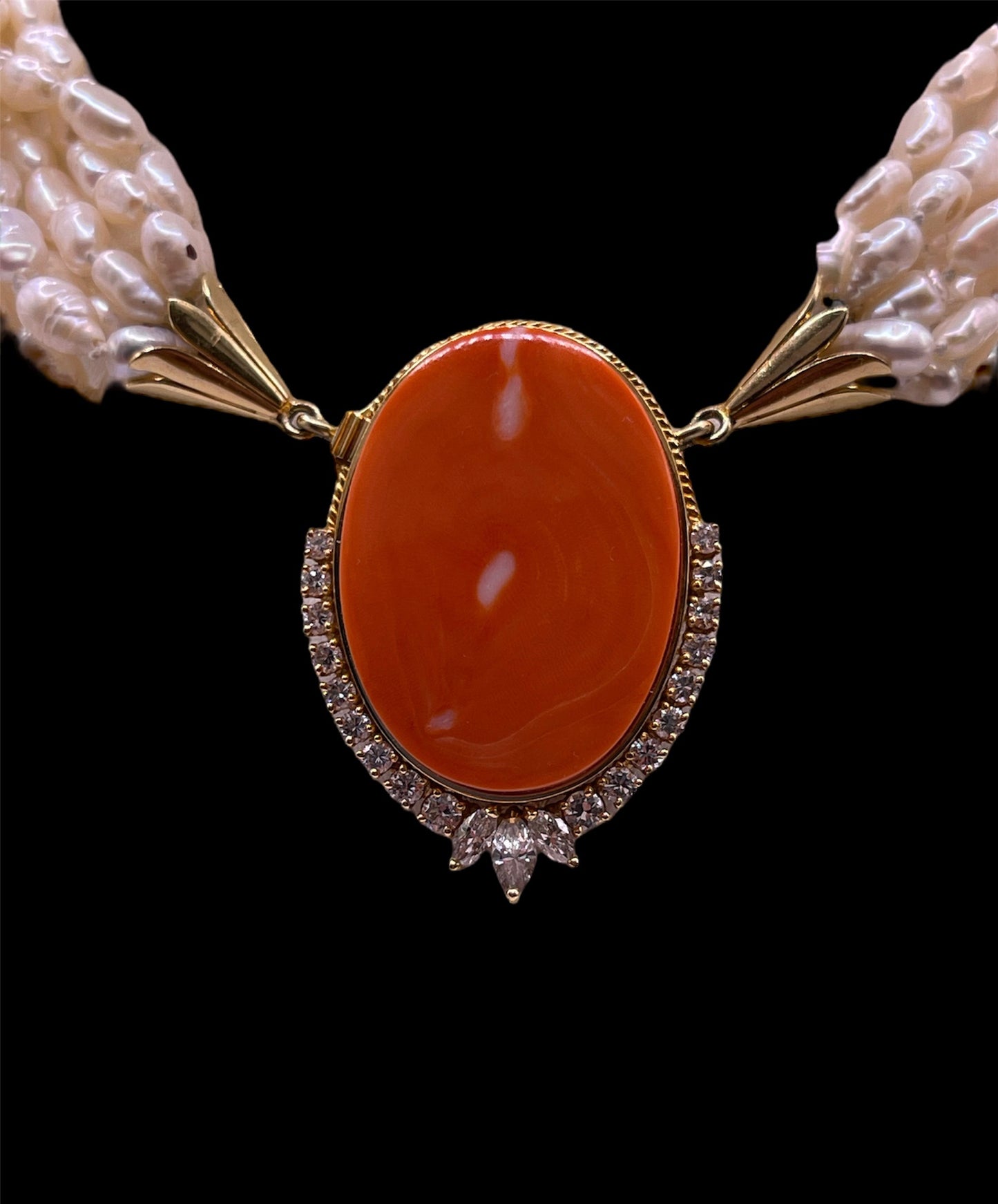 A pearl torsade with coral clasp