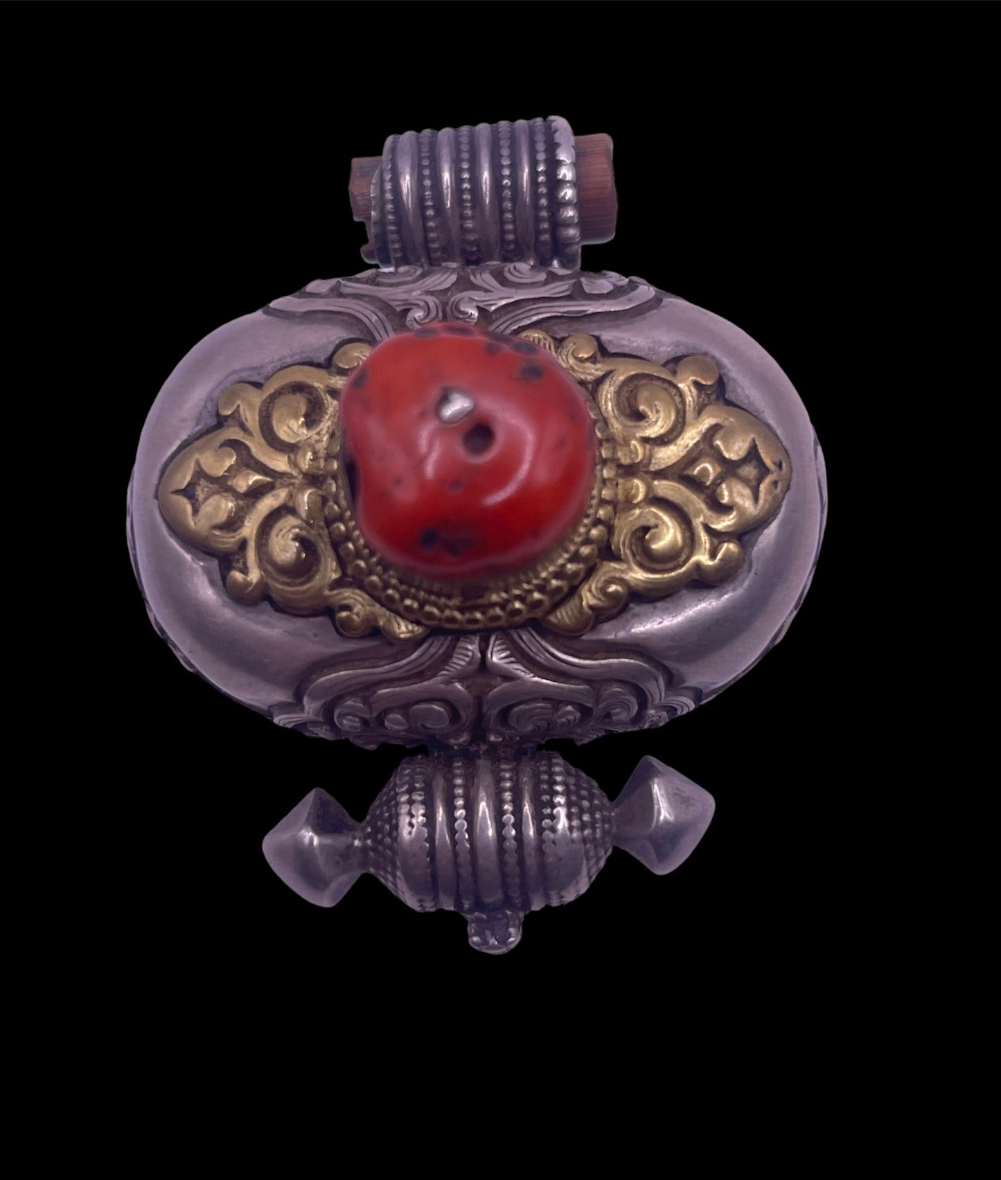 An antique silver and coral ghau amulet