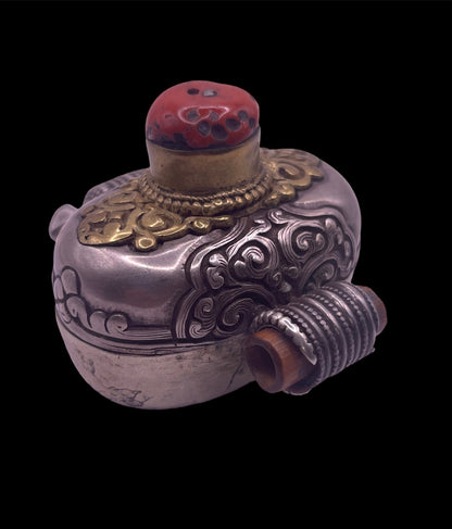 An antique silver and coral ghau amulet