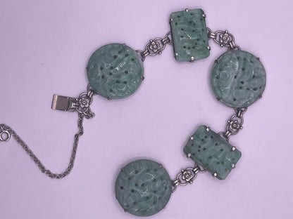 A silver bracelet with jade plaques