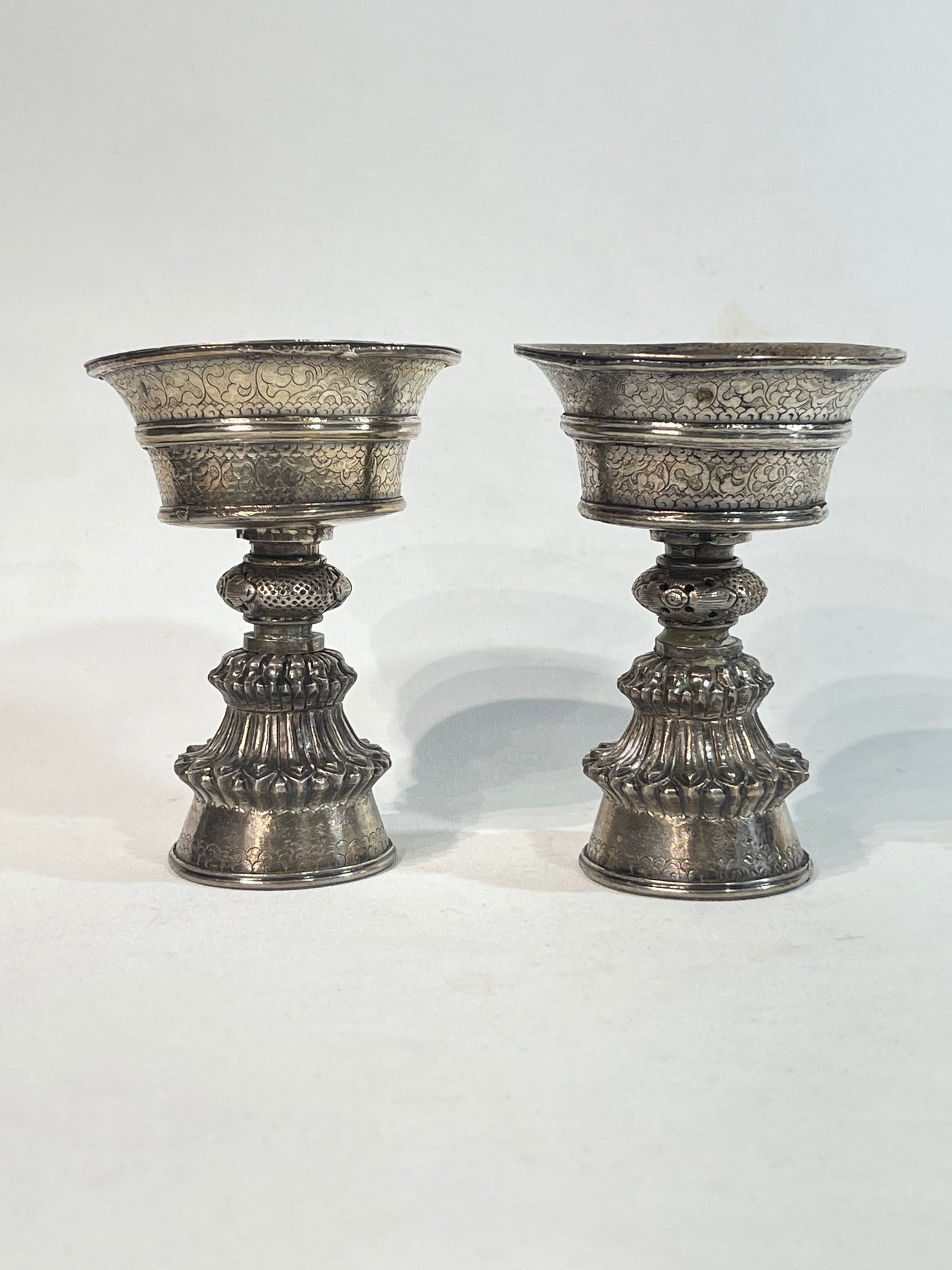 A pair of Tibetan silver butter lamps