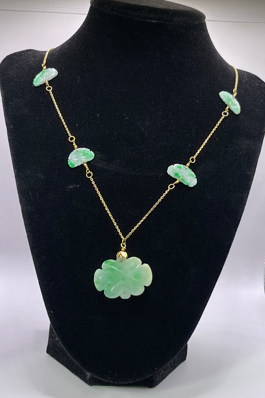 A vintage Art Deco style necklace with an antique apple green jade carved plaque and smaller plaques on 14kt chain