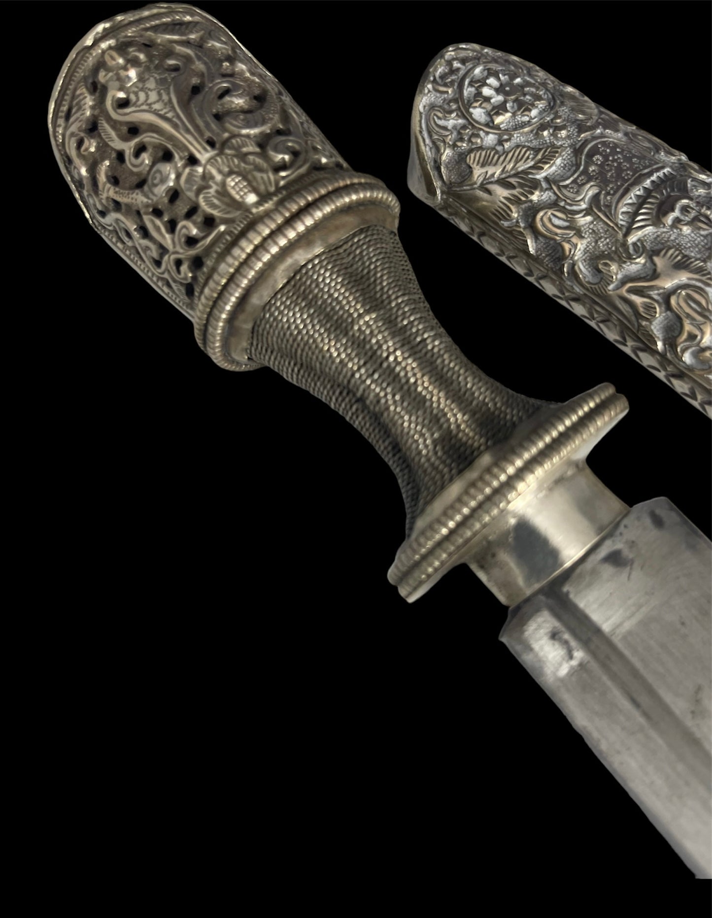 An antique Tibetan dagger with a carved silver sheath