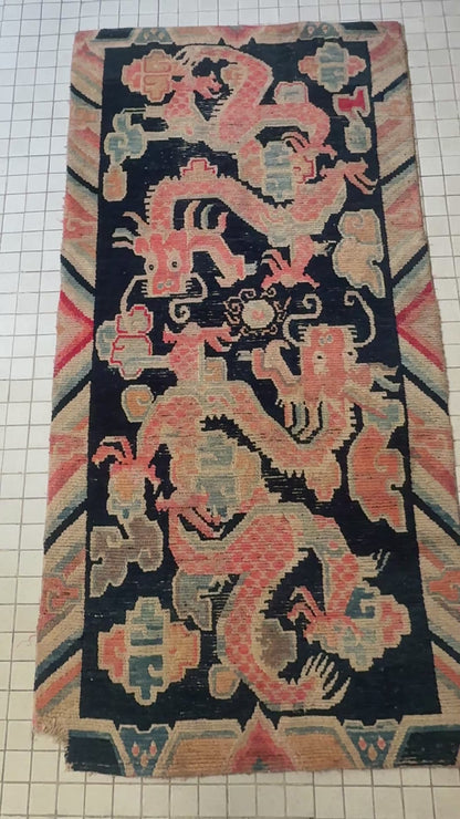 A 19th C., antique Tibetan dragon rug