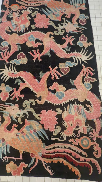 A mid 20th C., Tibetan dragon and phoenix rug