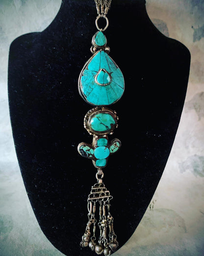 An antique turquoise and silver Tibetan ear pendant / earring