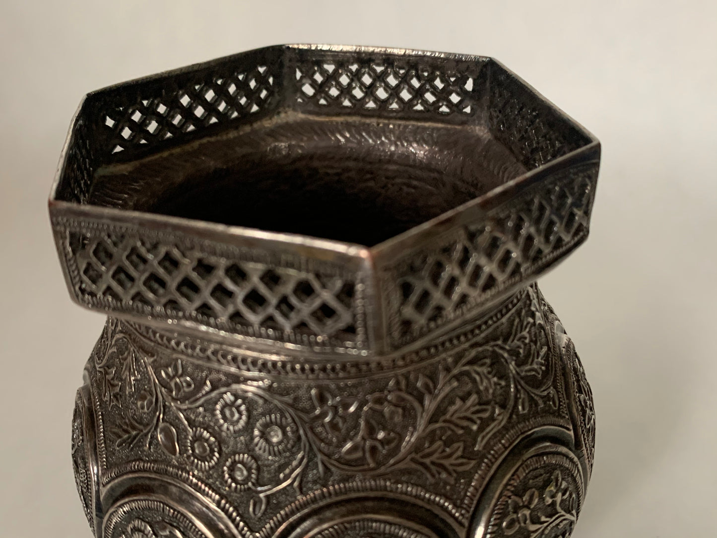 An exquisitely carved antique silver utensil -possibly a censer with floral details