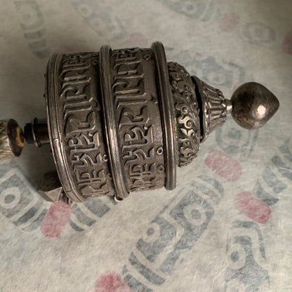 An antique Tibetan handheld prayer wheel