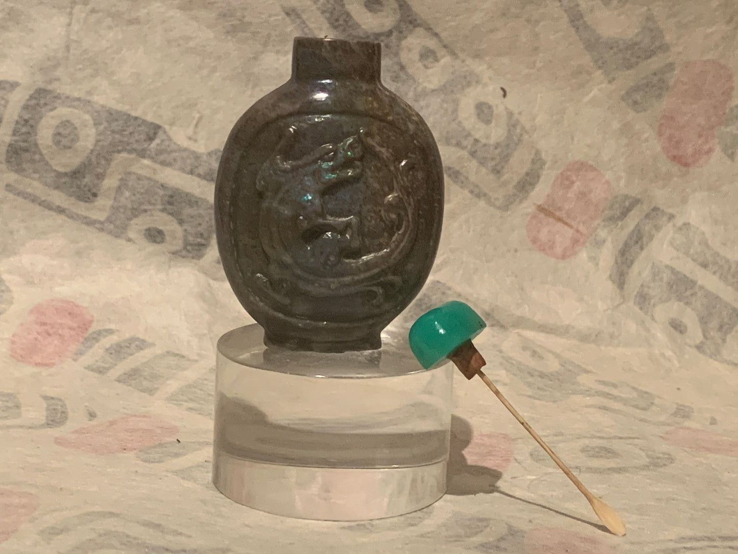 A carved opal snuff bottle with a jade stopper