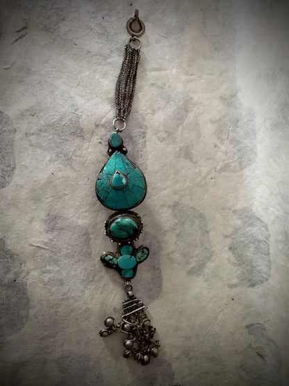 An antique turquoise and silver Tibetan ear pendant / earring
