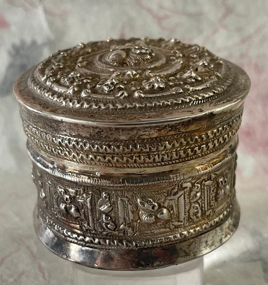 An antique silver south East Asian round box with lid