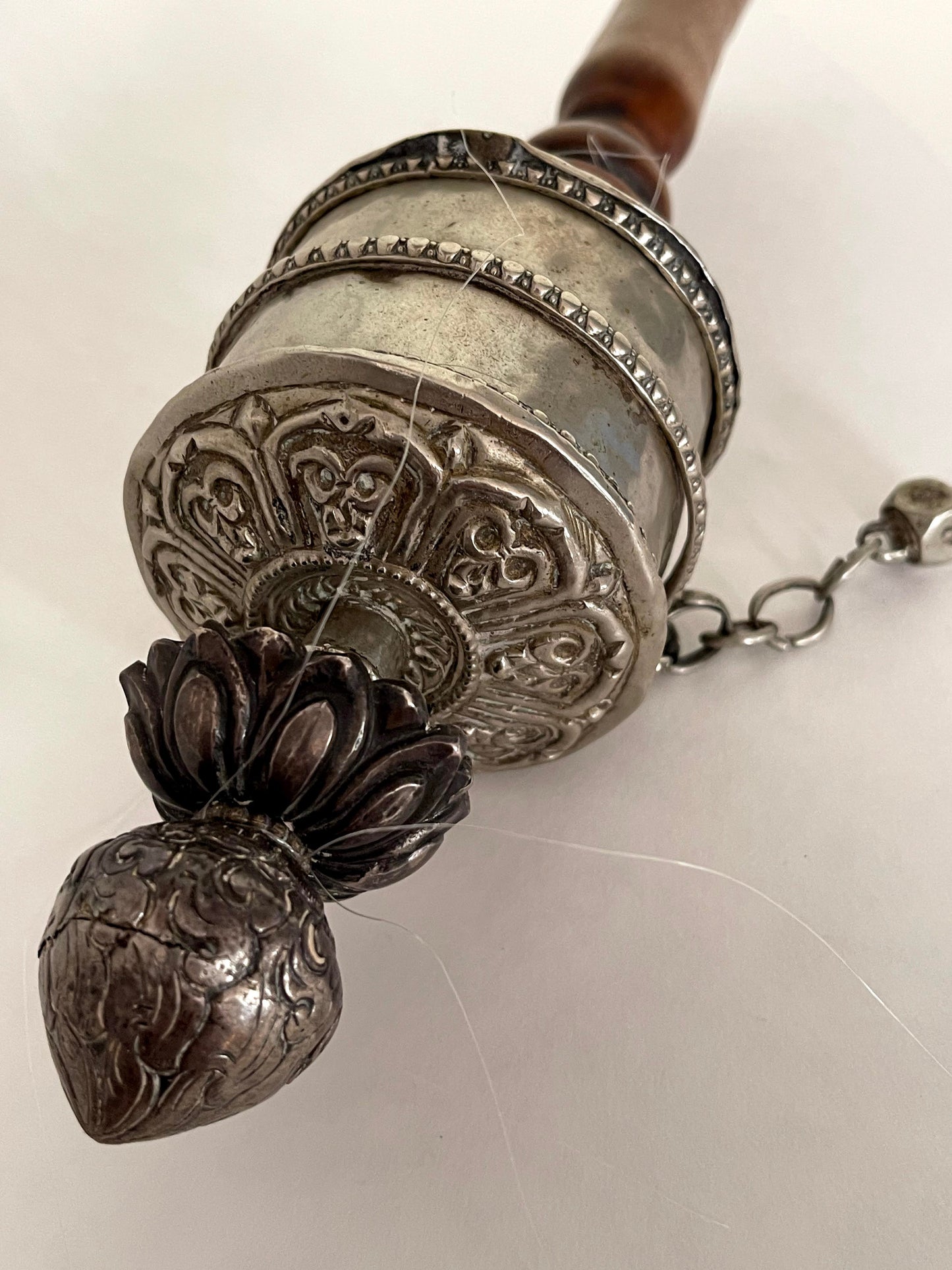 An original handmade vintage Tibetan silver handheld prayer wheel simply carved and decorated