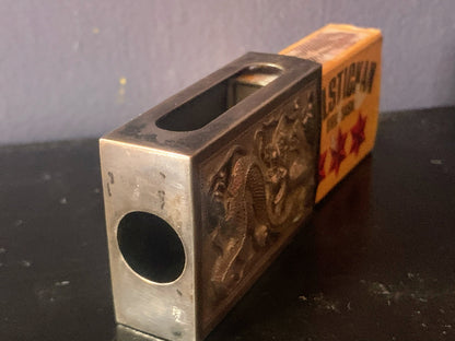 A silver matchbox cover