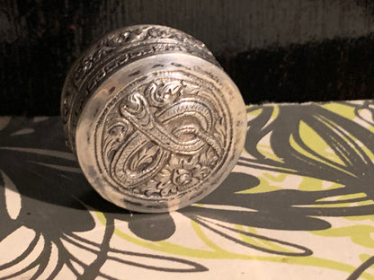 A small silver pill box