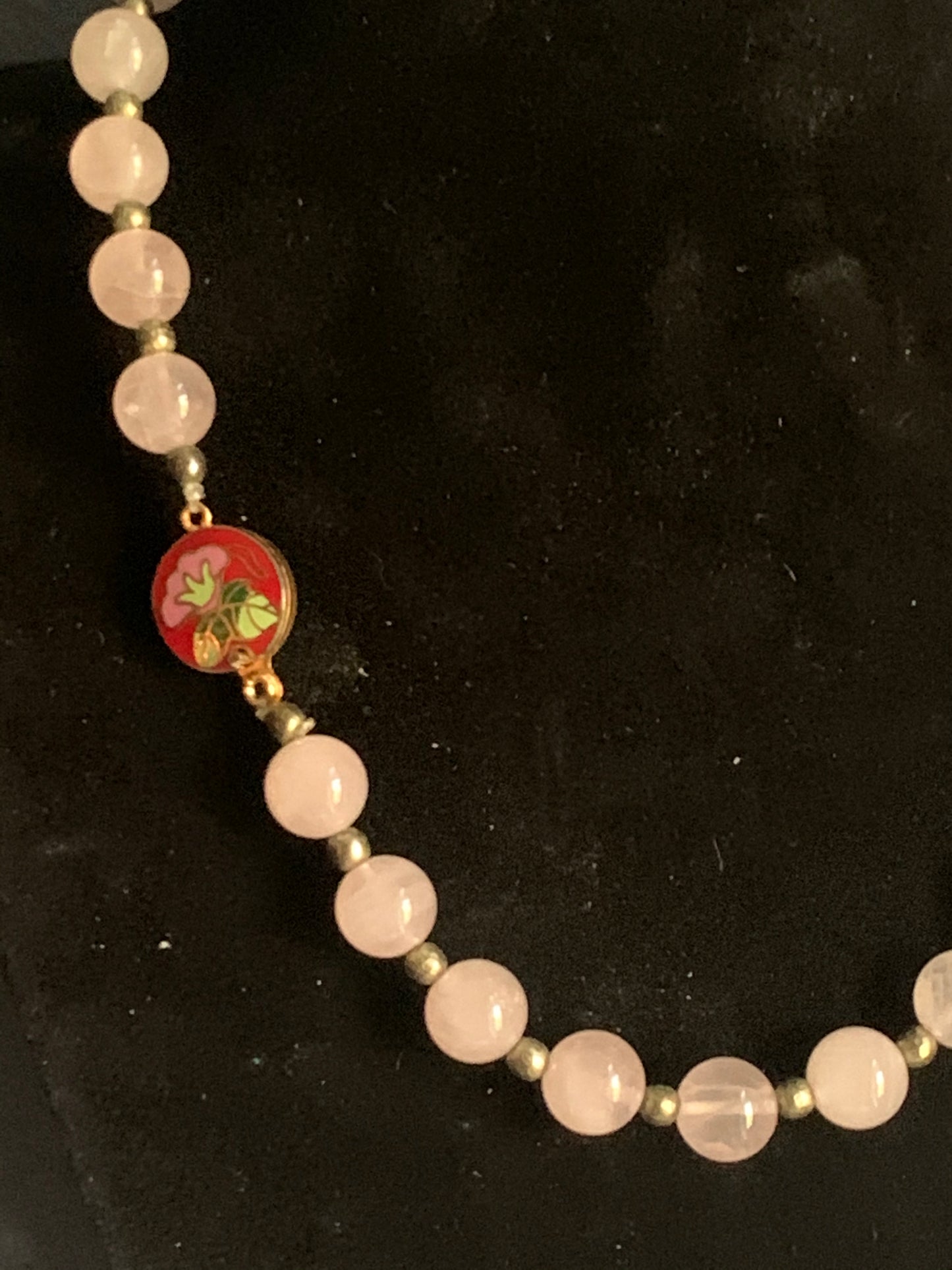 A necklace with rose quartz beads