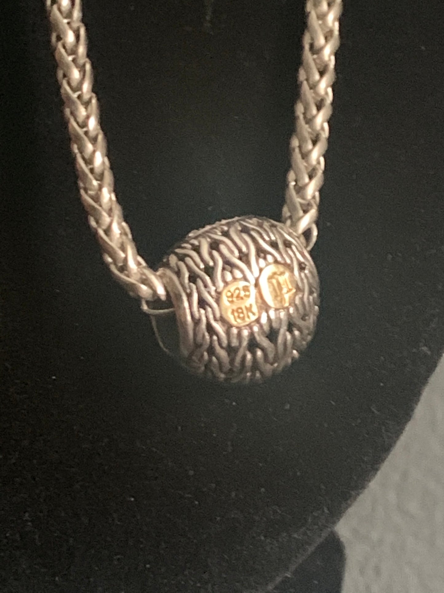 A silver chain with diamond pave pendant