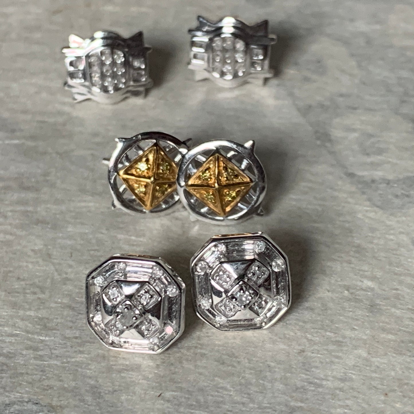 A set of three pairs of diamond ear studs in 10kt settings