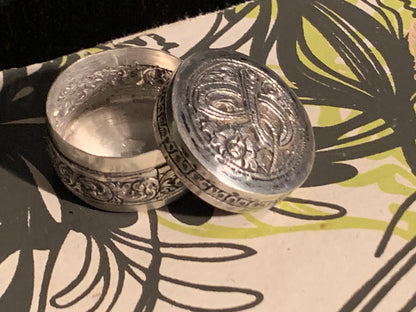 A small silver pill box