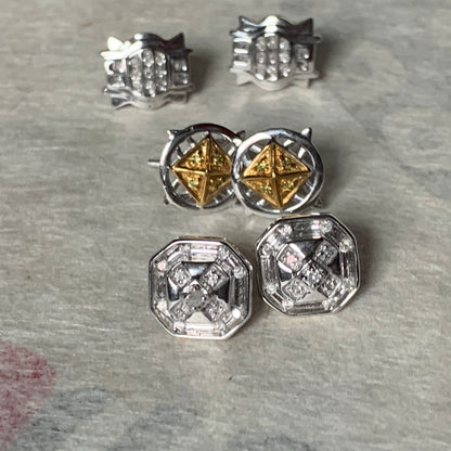 A set of three pairs of diamond ear studs in 10kt settings