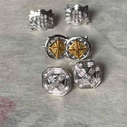 A set of three pairs of diamond ear studs in 10kt settings