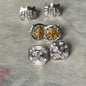 A set of three pairs of diamond ear studs in 10kt settings