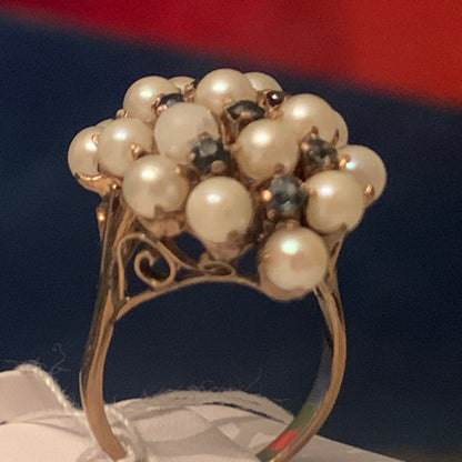 A pearl and sapphire ring in a 14kt setting
