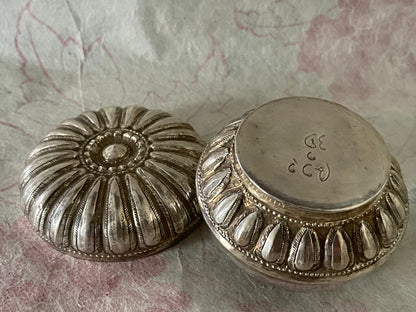 An antique silver south East Asian round box with lid