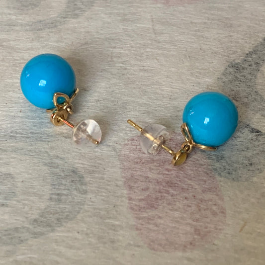 A pair of turquoise earrings