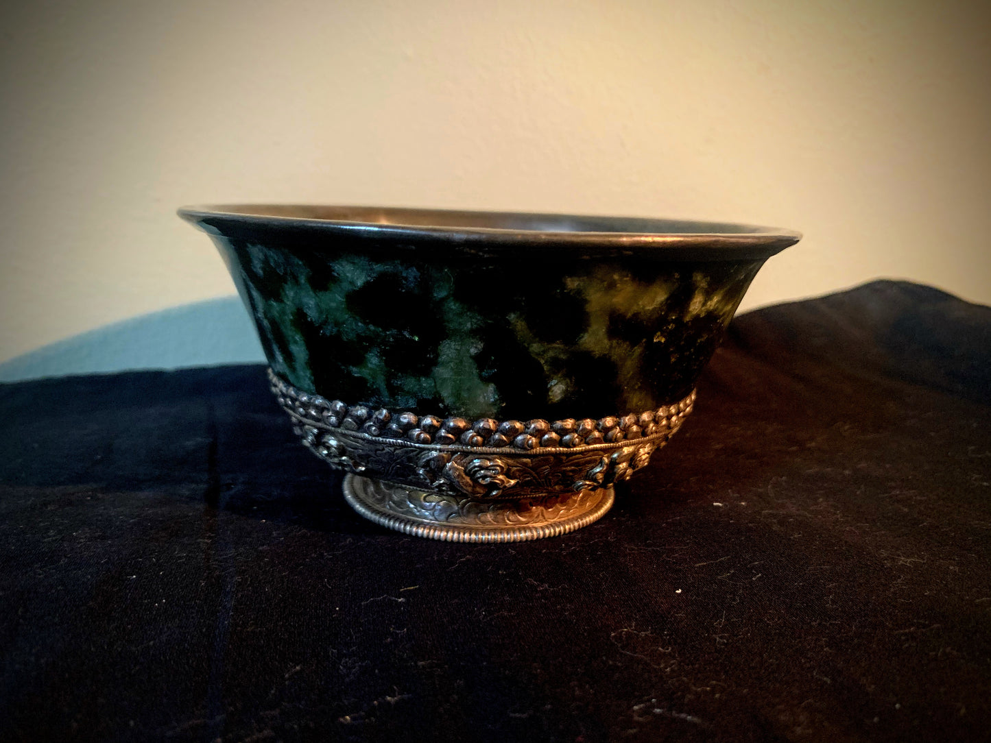 A jade bowl with silver details