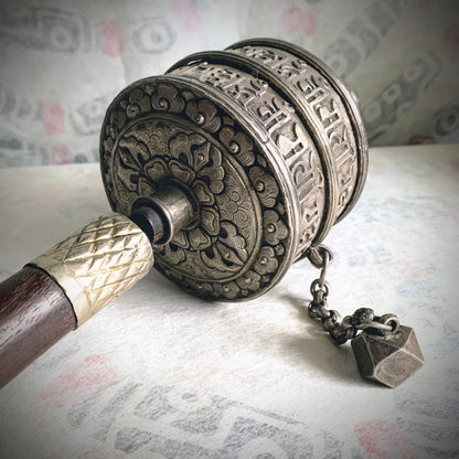 An antique Tibetan handheld prayer wheel