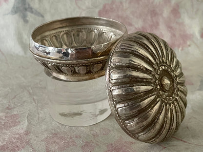 An antique silver south East Asian round box with lid