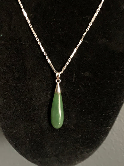 A jade tear drop ear ring and necklace in silver