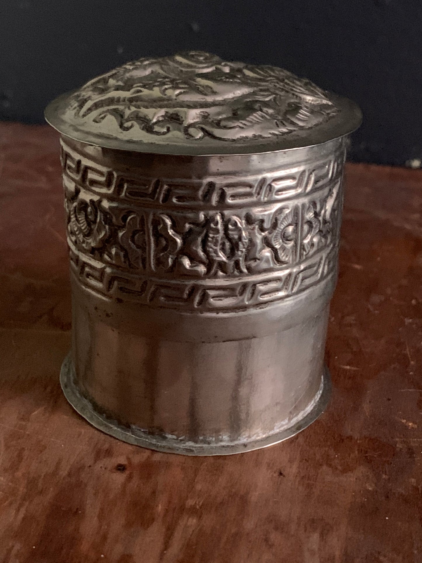 A cylindrical silver box