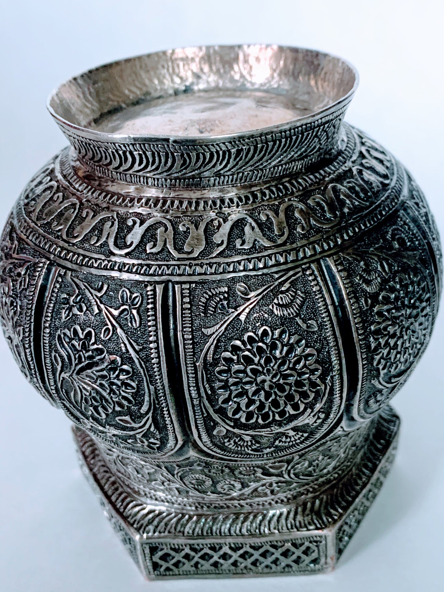 An exquisitely carved antique silver utensil -possibly a censer with floral details