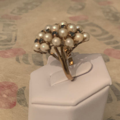 A pearl and sapphire ring in a 14kt setting