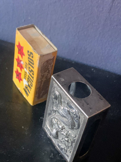 A silver matchbox cover