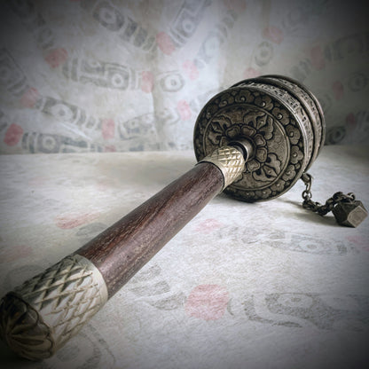 An antique Tibetan handheld prayer wheel